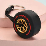 Luxury racing tire keychain featuring a black tire design with red and gold accents