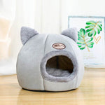 Cozy winter cat bed in grey with plush exterior and cute cat ears design for feline comfort
