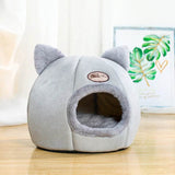 Cozy winter cat bed in grey with plush exterior and cute cat ears design for feline comfort