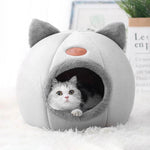 Cozy winter cat bed in gray with cute ears and soft interior for comfortable lounging