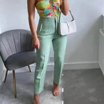 Trendy high-waist pencil pants women in mint green paired with a colorful top and white handbag