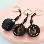 Luxury racing tire keychain set featuring three colorful tire designs on metal rings