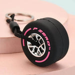 Luxury racing tire keychain with a detailed tire design and a silver wheel rim accent