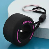 Luxury racing tire keychain in black and pink design with a textured finish for car enthusiasts
