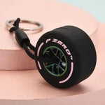 Luxury racing tire keychain with realistic tire design and detailed branding for car enthusiasts