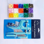 Snap pliers kit for cloth with colorful snap buttons organized in a clear storage case